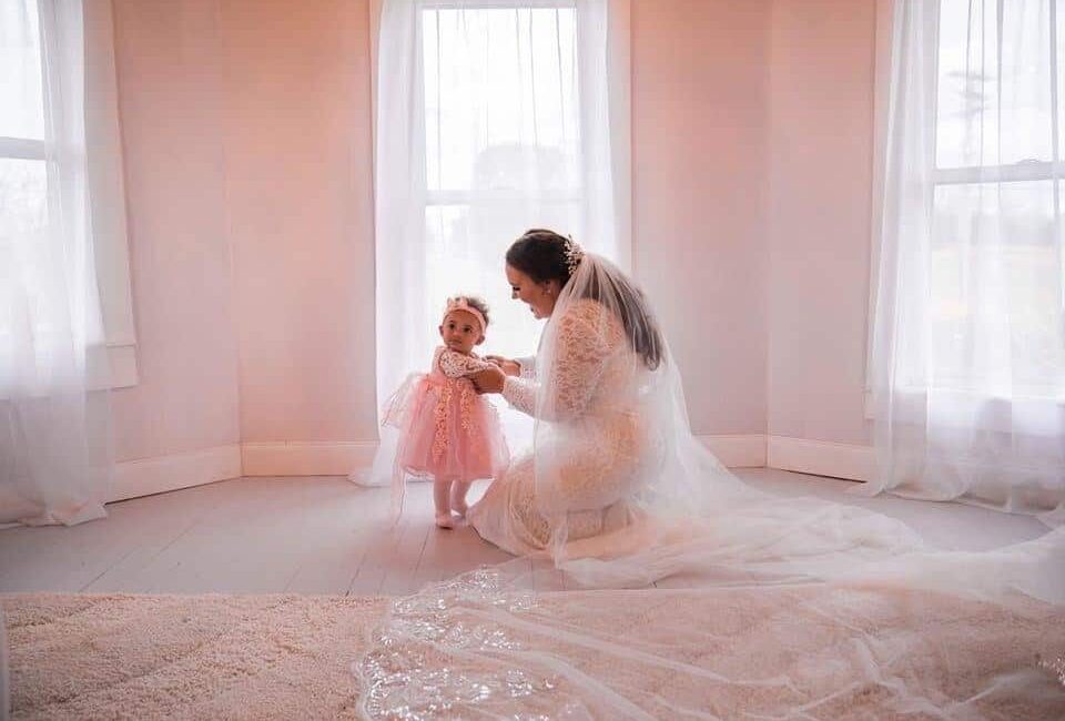 bride and flower girl in bridal suite
