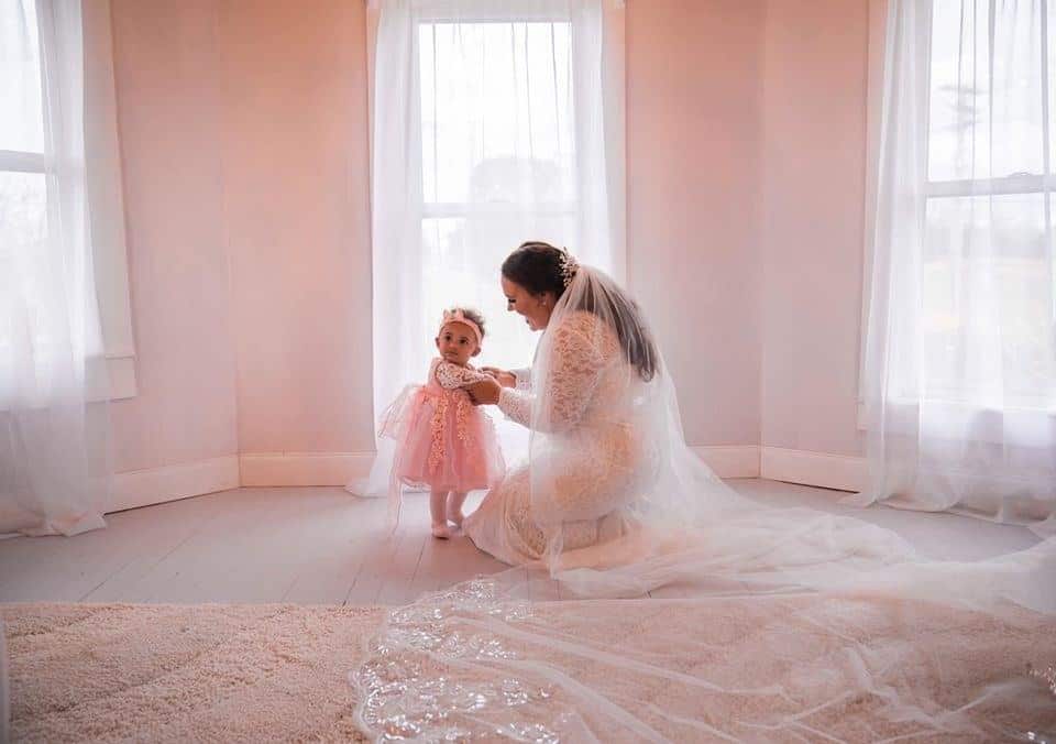 bride and flower girl in bridal suite