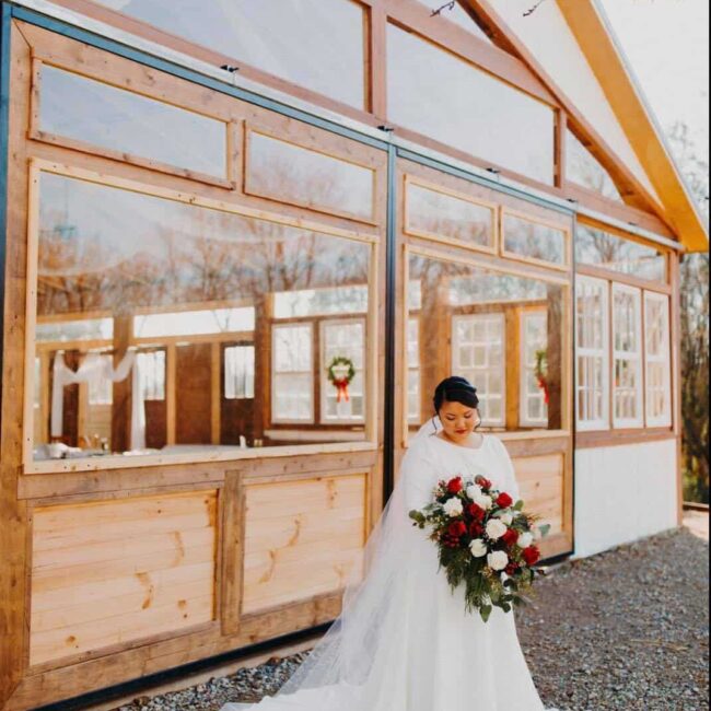 bride with bouquet in front of pavilion