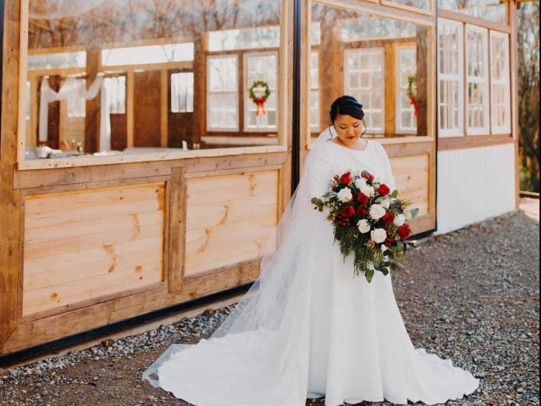 bride with bouquet in front of pavilion